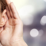 A,Woman,Holds,Hand,Near,Her,Ear,And,Listening,To