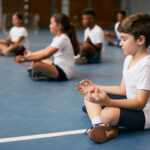 Group,Of,Elementary,Students,Doing,Breathing,Exercise,While,Practicing,Yoga